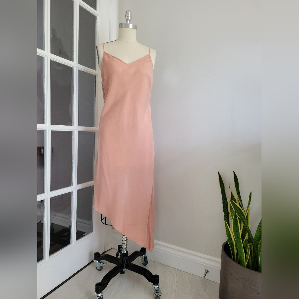 Asymmetrical slip bias cut dress in soft peach colour silk like fabric